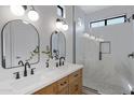 Beautiful bathroom with dual sinks, framed mirrors, and glass-enclosed shower at 19862 E Carriage Way, Queen Creek, AZ 85142