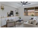 Comfortable living room featuring a ceiling fan, sofa, accent chair, and lots of light at 19862 E Carriage Way, Queen Creek, AZ 85142