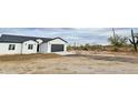 Newly built single-story home featuring a spacious two-car garage and minimal desert landscaping at 2133 N Valley Dr, Apache Junction, AZ 85120