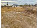 Expansive desert lot with scattered vegetation and a newly constructed home at 2133 N Valley Dr, Apache Junction, AZ 85120