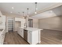 Open-concept kitchen with sleek appliances, an island, and access to the living area at 23805 N 163Rd Dr, Surprise, AZ 85387