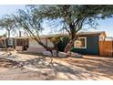 Features mature trees, desert landscaping, and a long driveway approaching the house at 2939 E Paradise Ln, Phoenix, AZ 85032