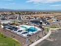 Community aerial view showcasing pool, playground, green space and surrounding homes and mountain views at 3550 E Audrey Dr, San Tan Valley, AZ 85143