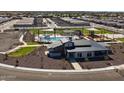 Aerial view of community clubhouse, pool, playground, green space, and surrounding neighborhood at 3550 E Audrey Dr, San Tan Valley, AZ 85143