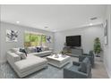 Bright living room featuring a large sofa, contemporary decor, and sliding glass doors to the backyard at 3551 E Louise Dr, Phoenix, AZ 85050