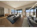 Spacious living room with floor to ceiling windows, hardwood floors and modern decor at 39332 N Old Stage Rd, Cave Creek, AZ 85331