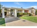 Charming home with a covered carport, lion statues, and well-maintained landscaping at 440 W 1St W St, Mesa, AZ 85201