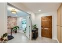 Stylish entryway featuring a brick accent wall, natural lighting, and a modern door at 4416 N 18Th Pl, Phoenix, AZ 85016