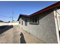 Side exterior of a light colored stucco building with a dark grey roof at 4825 N 35Th Ave, Phoenix, AZ 85017