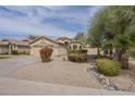 Inviting single-story home with a well-manicured desert front yard and ample driveway space at 486 E Devon Dr, Gilbert, AZ 85296