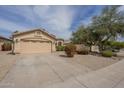 Attractive single-story home with a two-car garage, long driveway, and desert landscaping at 486 E Devon Dr, Gilbert, AZ 85296