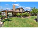 Expansive backyard with lush lawn, covered patio, and mature landscaping perfect for outdoor living at 4909 E Dallas St, Mesa, AZ 85205