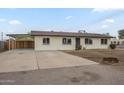 Charming single-story home featuring a covered driveway and a well-maintained front yard at 562 N 104Th St, Mesa, AZ 85207