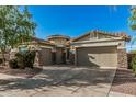 Charming single-story home with stone accents, well-maintained landscaping and a three-car garage at 612 E Riviera Dr, Chandler, AZ 85249