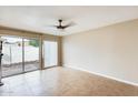 Bright bedroom with sliding glass doors, neutral walls, and sleek tile flooring for easy maintenance at 1051 S Dobson Rd # 117, Mesa, AZ 85202