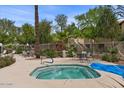 Inviting community hot tub and seating area surrounded by lush greenery and landscaping at 1351 N Pleasant Dr # 1087, Chandler, AZ 85225