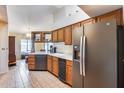 Well-lit kitchen with stainless steel appliances, wooden cabinets, and a breakfast nook at 14782 W Belmont Dr, Casa Grande, AZ 85194