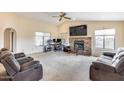 Spacious living room features a fireplace, vaulted ceiling, and comfortable seating at 14782 W Belmont Dr, Casa Grande, AZ 85194