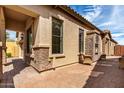 Cozy outdoor patio with a brick fireplace, wicker furniture, and pavers offering a relaxing ambiance at 1631 N Lynch --, Mesa, AZ 85207