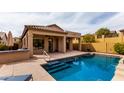 Sparkling pool with steps and a Baja shelf offers a refreshing retreat in the backyard at 1631 N Lynch --, Mesa, AZ 85207