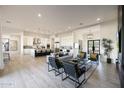 Spacious open-concept living area featuring light hardwood floors and modern decor at 1940 E Creek Canyon Rd, Phoenix, AZ 85086