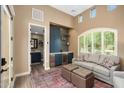 Stylish living room featuring a beverage bar, high ceilings, and natural light at 30396 N 72Nd Pl, Scottsdale, AZ 85266