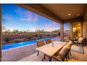Covered patio overlooking the pool area, ideal for outdoor dining and relaxation at 30396 N 72Nd Pl, Scottsdale, AZ 85266