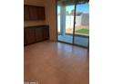 Well-lit room with a door to the backyard, features tile flooring and upper/lower cabinets with granite countertops at 36217 N Urika Dr, San Tan Valley, AZ 85140