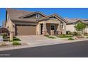 Lovely home with a two-car garage, stone accents, and a well-maintained front yard with desert landscaping at 4156 E Bernice St, Gilbert, AZ 85295