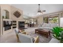 Bright living room featuring a fireplace, neutral colors, and an open floor plan at 4518 E Aspen Way, Gilbert, AZ 85234