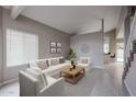 Bright and airy living room with tile floors, a white sofa, and a modern design at 4613 E Douglas Ave, Gilbert, AZ 85234