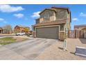 Two-story home with a two-car garage, low-maintenance landscaping, and an extended driveway at 6409 S 49Th Dr, Laveen, AZ 85339