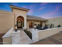 An inviting entrance featuring stone columns and pavers, leading to an elegant front door with outside seating at 7481 E Camino Santo --, Scottsdale, AZ 85260