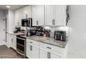 Bright kitchen featuring white cabinets, gray countertops, stainless steel appliances, and tiled backsplash at 8576 W Mclellan Rd, Glendale, AZ 85305