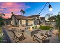 Inviting backyard featuring a fire pit, patio seating, and string lights at 8781 S Mill Ave, Tempe, AZ 85284