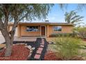 Inviting single-story home with xeriscape yard, solar panels, and charming curb appeal at 1031 W Cornell Dr, Tempe, AZ 85283