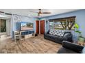 Cozy living room featuring a ceiling fan, wood-look tile floors, and a view of the front yard at 1031 W Cornell Dr, Tempe, AZ 85283