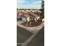 Single-story home with tile roof, two car garage, brown gravel, and rock front yard at 10463 W Medlock Dr, Glendale, AZ 85307