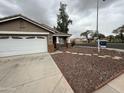 Well-maintained single-story home with front yard landscaping and covered entryway at 10463 W Medlock Dr, Glendale, AZ 85307