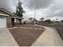 Single-story house with brown gravel landscaping and shade tree at 10463 W Medlock Dr, Glendale, AZ 85307