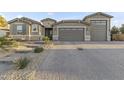 Charming home features a three car garage and professional landscaping with desert landscaping at 12531 W Tuckey Ln, Glendale, AZ 85307