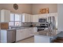 Bright kitchen featuring white cabinets, stainless steel appliances, and a stylish breakfast bar at 1550 E Park Ave, Gilbert, AZ 85234