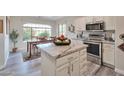 Modern kitchen featuring stainless steel appliances, granite countertops, and adjacent dining space at 16131 W Indianola Ave, Goodyear, AZ 85395