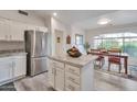 Bright kitchen with stainless steel appliances, granite countertops, and a cozy dining area at 16131 W Indianola Ave, Goodyear, AZ 85395
