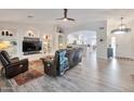 Inviting living room featuring vaulted ceilings, built-in shelving, and wood-look tile flooring at 16131 W Indianola Ave, Goodyear, AZ 85395