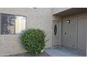 Charming home with well-maintained front yard landscaping featuring a flowering shrub and a light-colored stucco facade at 16616 E Palisades Blvd # 109, Fountain Hills, AZ 85268