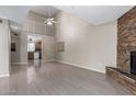 Bright living room featuring a fireplace, vaulted ceiling, and loft at 16616 E Palisades Blvd # 109, Fountain Hills, AZ 85268