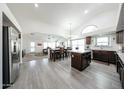Open-concept kitchen featuring an island, stainless steel appliances, and wood-look tile flooring at 19622 N 66Th Ln, Glendale, AZ 85308