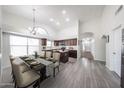 Open concept kitchen and dining room with a large island, stainless steel appliances, and modern finishes at 19622 N 66Th Ln, Glendale, AZ 85308