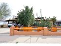 Charming brick home with a custom wooden fence showcasing Southwestern curb appeal at 2619 W Lamar Rd, Phoenix, AZ 85017